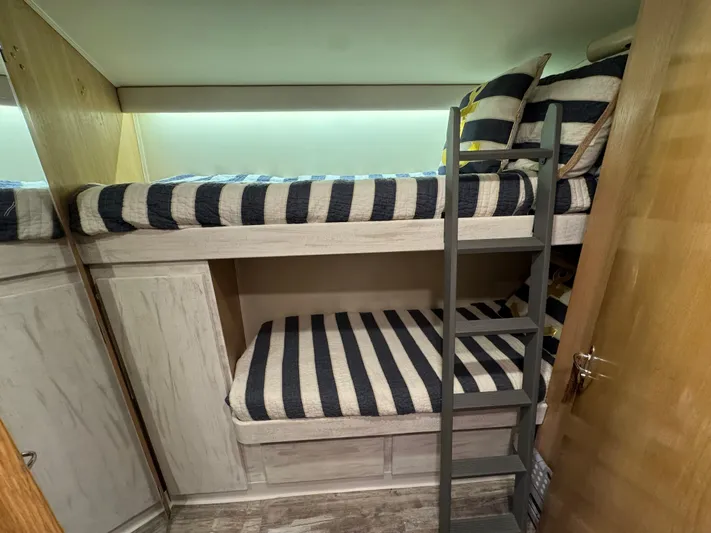 Negotiator Yacht Photos Pics Bunk beds with striped bedding in 1994 Hatteras 54 Convertible yacht cabin.
