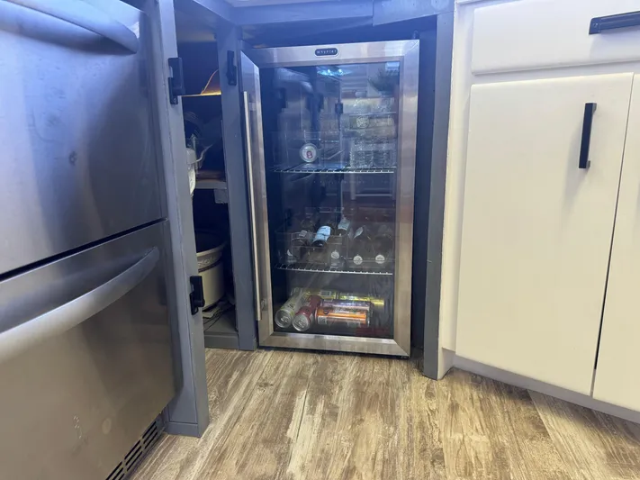 Negotiator Yacht Photos Pics Mini fridge stocked with beverages in a modern kitchen on a 1994 Hatteras 54 Convertible.