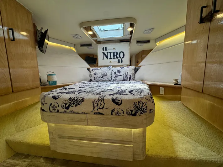 Negotiator Yacht Photos Pics Luxurious cabin interior of 1994 Hatteras 54 Convertible yacht with elegant bedding and wood finishes.