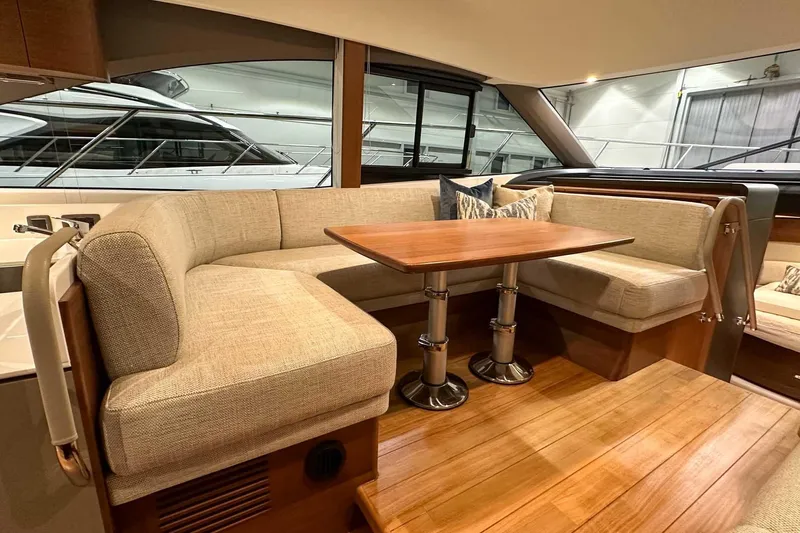 F45021 Yacht Photos Pics Luxurious interior of 2021 Princess F45 yacht with elegant seating and wooden table.