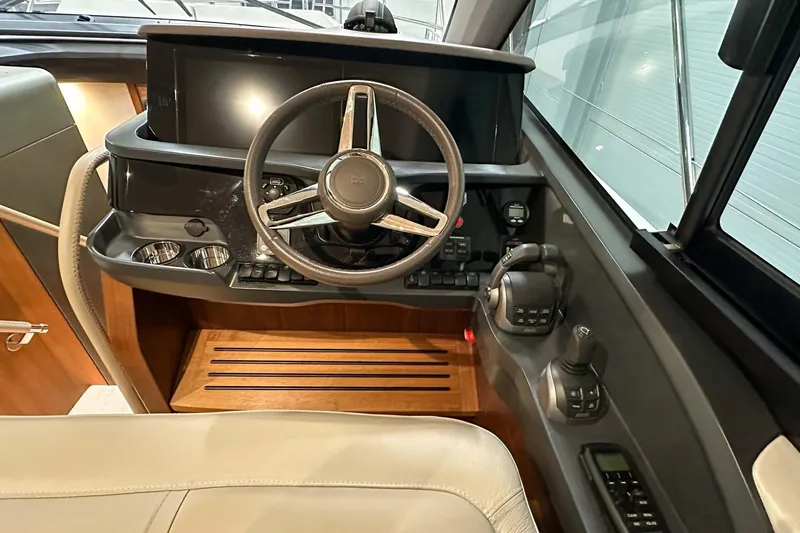 F45021 Yacht Photos Pics Interior helm of 2021 Princess F45 yacht with steering wheel and controls.