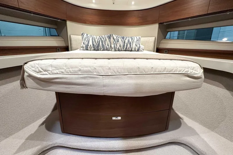 F45021 Yacht Photos Pics Luxurious 2021 Princess F45 yacht bedroom with elegant bedding and wooden accents.