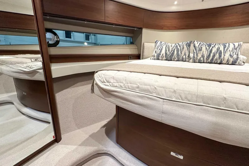 F45021 Yacht Photos Pics Luxurious interior of 2021 Princess F45 yacht with elegant bedding and wood finishes.