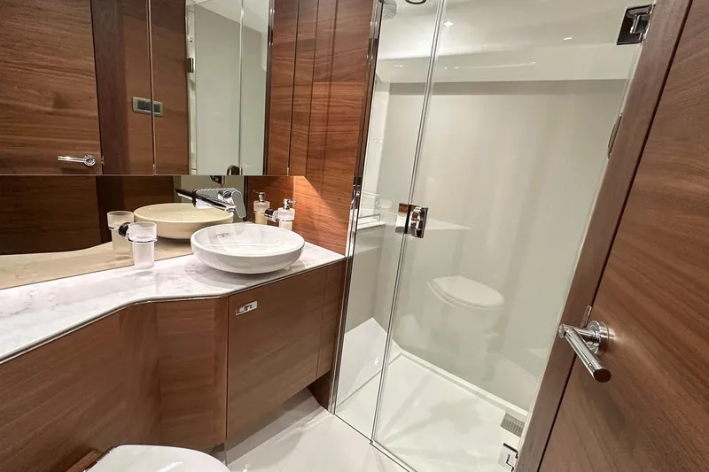 F45021 Yacht Photos Pics Luxurious bathroom in 2021 Princess F45 yacht with modern fixtures and wooden cabinetry.