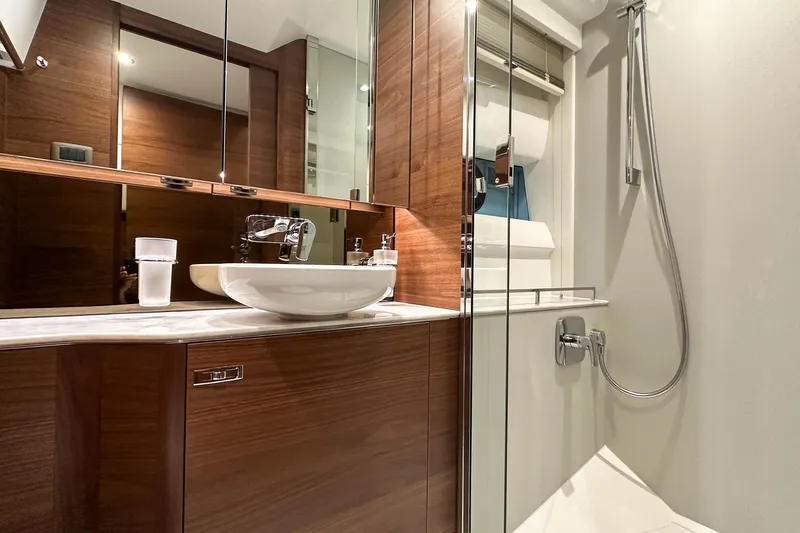 F45021 Yacht Photos Pics Luxurious bathroom in 2021 Princess F45 yacht with modern fixtures and wood accents.