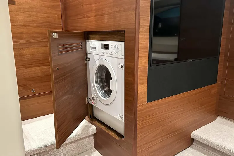 F45021 Yacht Photos Pics Hidden washing machine in 2021 Princess F45 yacht's wooden interior.