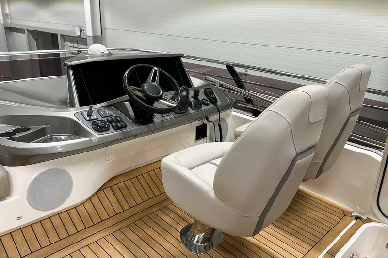 F45021 Yacht Photos Pics Luxury 2021 Princess F45 yacht helm with modern controls and plush seating.