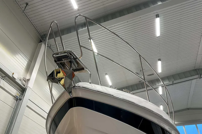 F45021 Yacht Photos Pics 2021 Princess F45 yacht bow in indoor storage, showcasing sleek design and stainless steel railings.