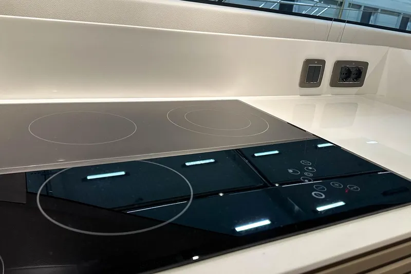 F45021 Yacht Photos Pics Modern kitchen cooktop on 2021 Princess F45 yacht, featuring sleek design and integrated controls.