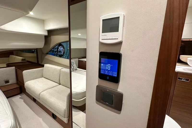 F45021 Yacht Photos Pics Interior of 2021 Princess F45 yacht with modern controls and elegant seating area.