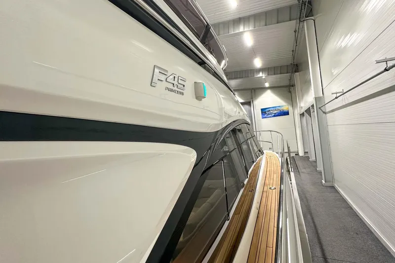 F45021 Yacht Photos Pics 2021 Princess F45 yacht in a showroom, showcasing sleek design and luxury features.