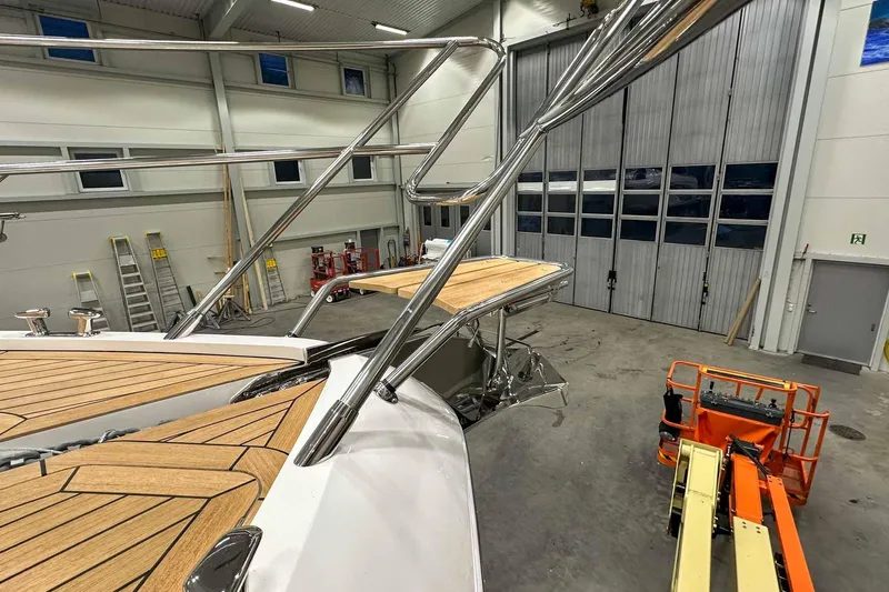 F45021 Yacht Photos Pics 2021 Princess F45 yacht in a spacious indoor facility, showcasing sleek design and craftsmanship.