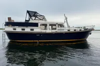 Custom Knight Craft 12,50 yacht, 2005 model, anchored on calm water under overcast sky.