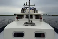 Custom Knight Craft 12,50 yacht from 2005 on calm waters under cloudy skies.