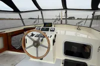Helm of 2005 Custom Knight Craft 12,50 boat with steering wheel and navigation equipment.