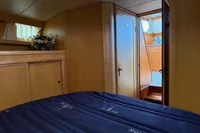 Cozy cabin interior of 2005 Custom Knight Craft 12,50 yacht with wooden finish.