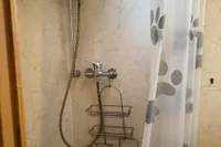 Shower area in 2005 Custom Knight Craft 12,50 with curtain and wall-mounted caddy.