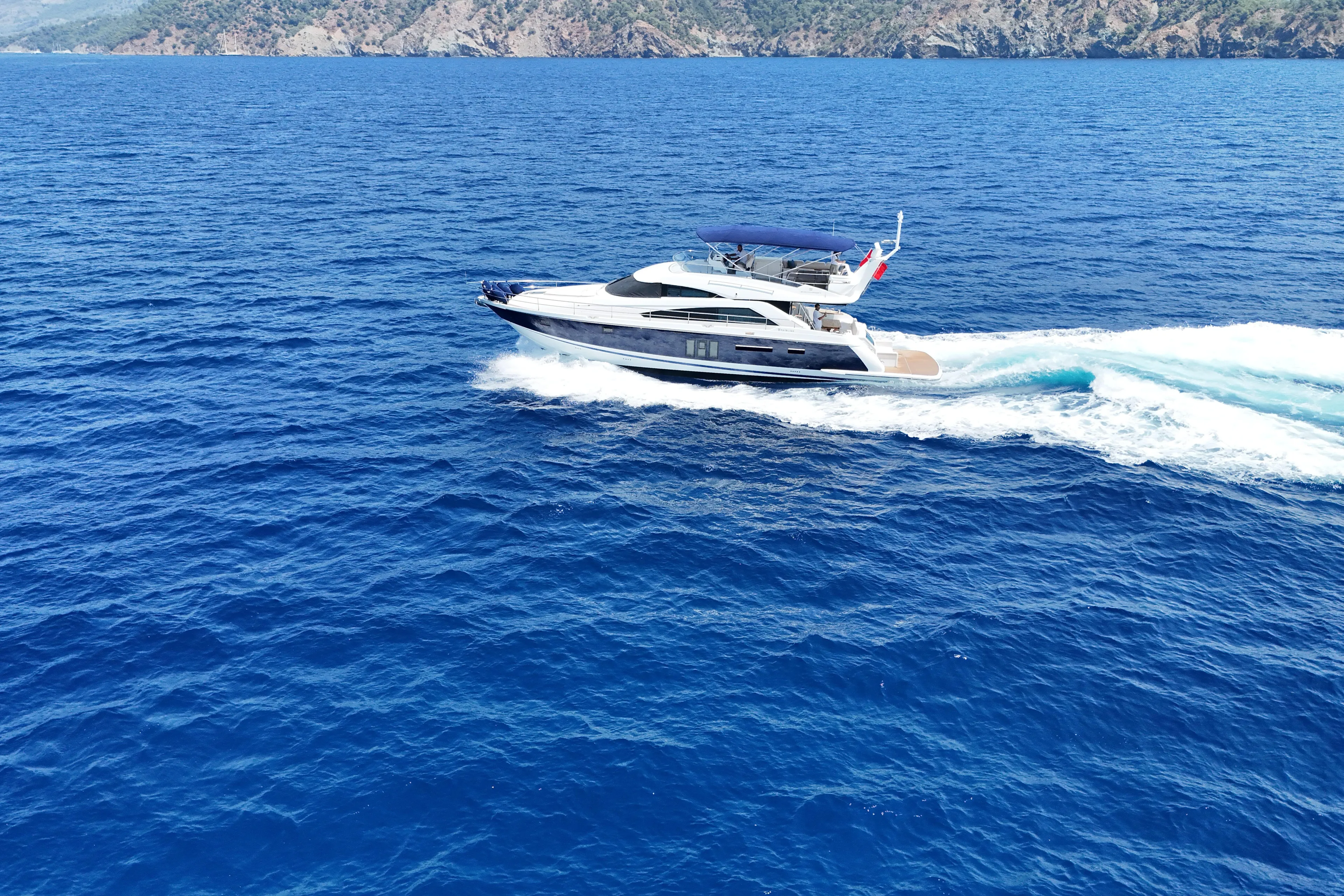  Yacht Photos Pics Luxurious 2013 Fairlane Squadron yacht cruising on vibrant blue ocean waters.
