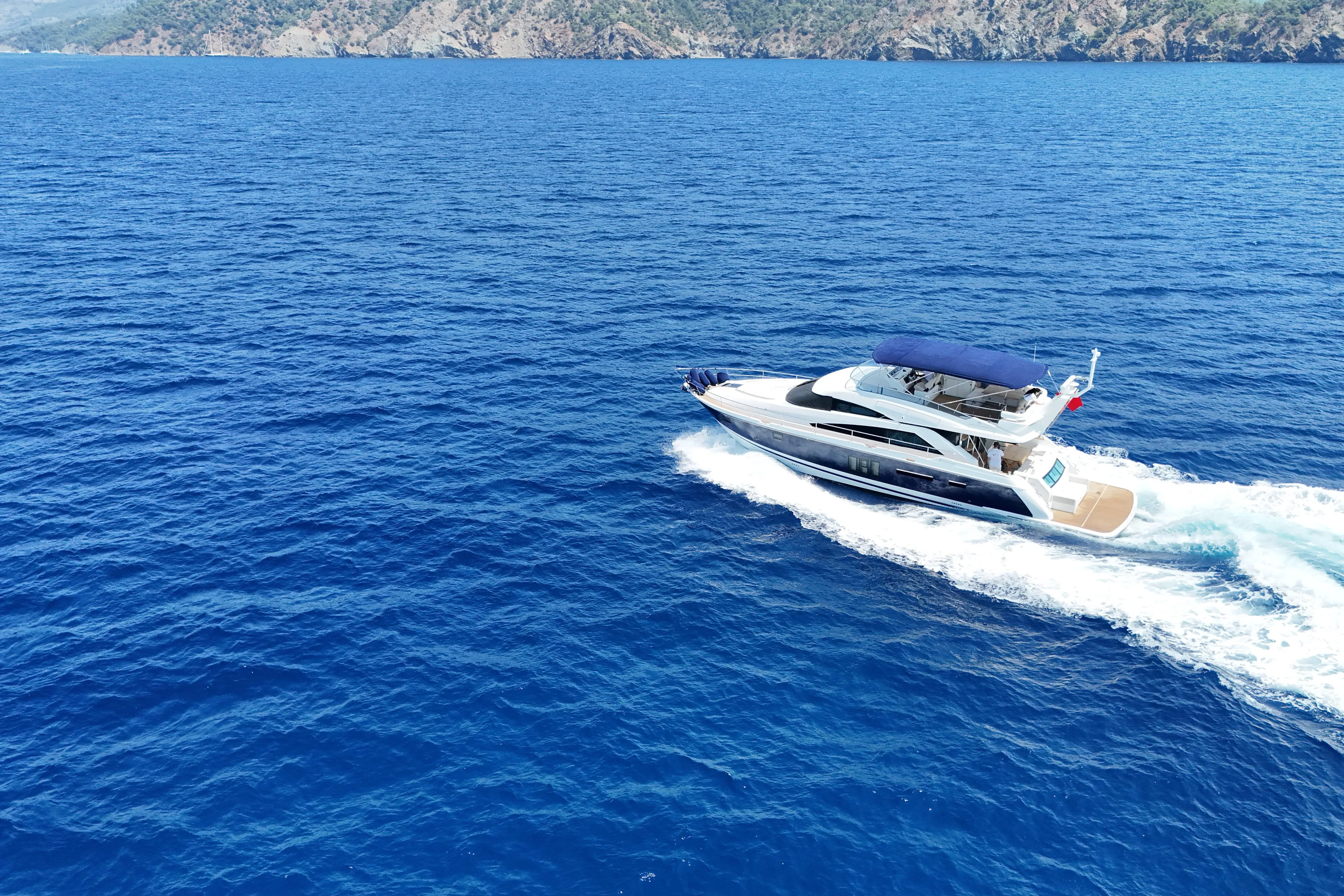  Yacht Photos Pics A 2013 Fairlane Squadron yacht cruising on clear blue ocean waters.