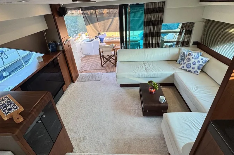  Yacht Photos Pics Luxurious yacht interior with white leather seating, wooden accents, and ocean view. Fairlane Squadron 2013.