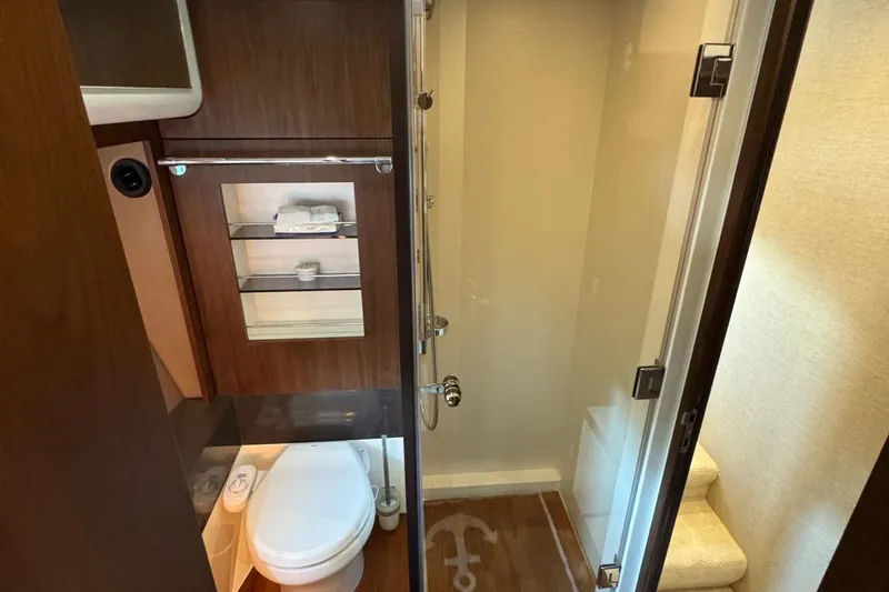  Yacht Photos Pics Luxurious bathroom interior of 2013 Fairlane Squadron yacht with modern fixtures and wooden accents.