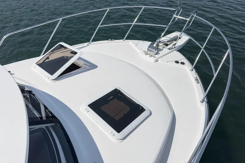 Sea Horse Yacht Photos Pics 2023 Cutwater 288 Coupe LE boat deck with open hatches on calm water.