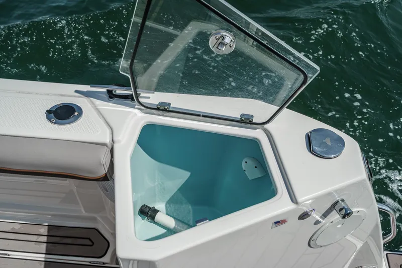 Sea Horse Yacht Photos Pics Open storage compartment on 2023 Cutwater 288 Coupe LE boat, with ocean background.