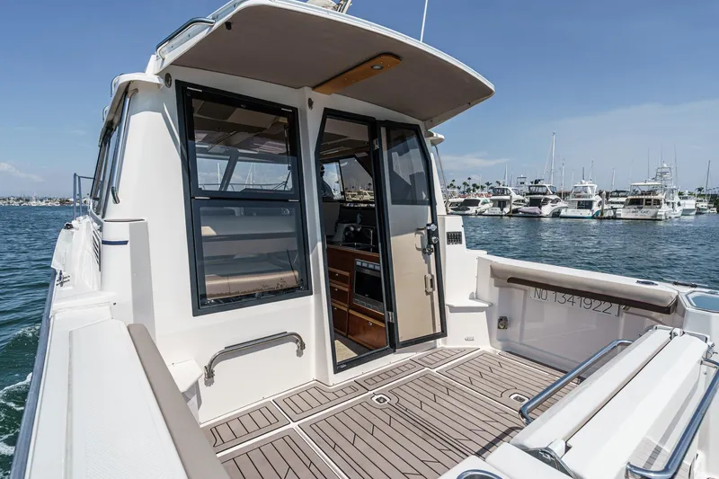 Sea Horse Yacht Photos Pics 2023 Cutwater 288 Coupe LE boat docked, featuring spacious deck and modern design.