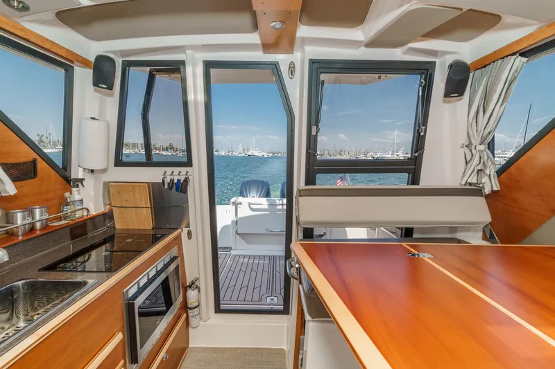 Sea Horse Yacht Photos Pics Interior of 2023 Cutwater 288 Coupe LE boat with kitchen and ocean view.