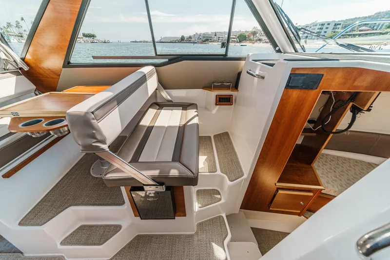 Sea Horse Yacht Photos Pics Interior of 2023 Cutwater 288 Coupe LE boat with seating and wooden accents.