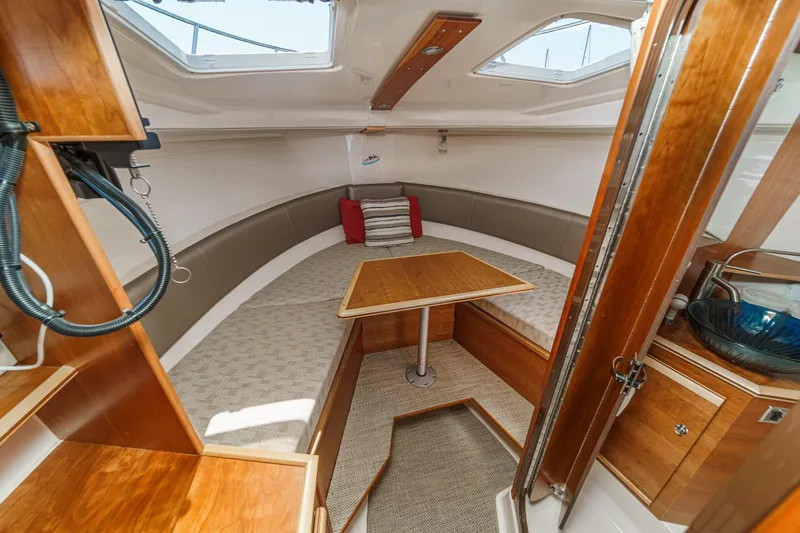 Sea Horse Yacht Photos Pics 2023 Cutwater 288 Coupe LE interior with wood finish and seating area.