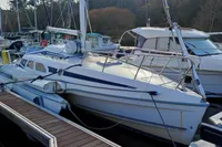 2002 Dragonfly 920 sailboat docked in a marina, surrounded by other boats.