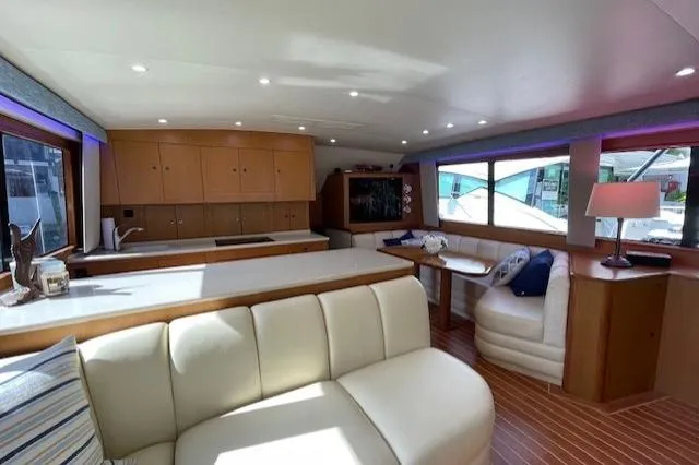 Luxurious interior of 2003 Post Flybridge Convertible yacht with modern seating and ample natural light.