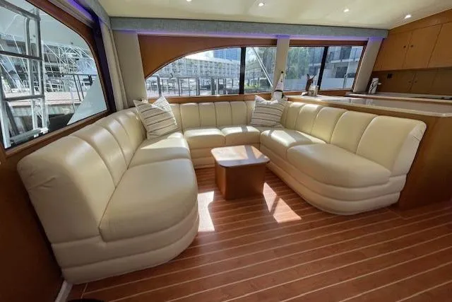Ala-ash Yacht Photos Pics Luxurious interior of 2003 Post Flybridge Convertible yacht with plush seating and wooden flooring.