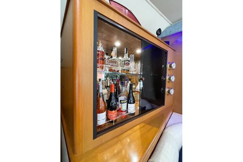 Ala-ash Yacht Photos Pics Bar cabinet with assorted liquor bottles on a 2003 Post Flybridge Convertible yacht.