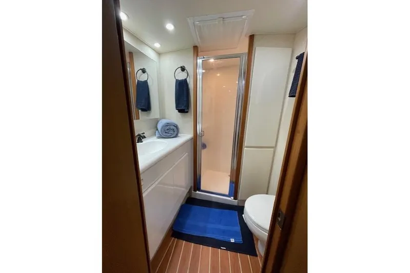 Ala-ash Yacht Photos Pics 2003 Post Flybridge Convertible yacht bathroom with shower, sink, and toilet.