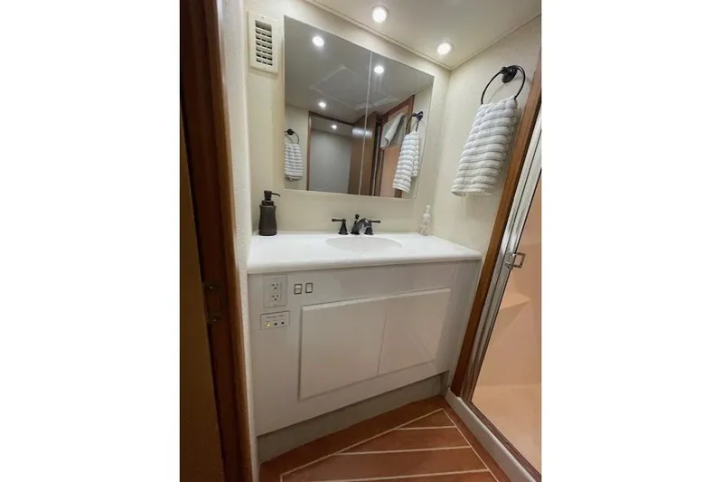 Ala-ash Yacht Photos Pics Luxurious bathroom in 2003 Post Flybridge Convertible yacht with modern fixtures and elegant design.