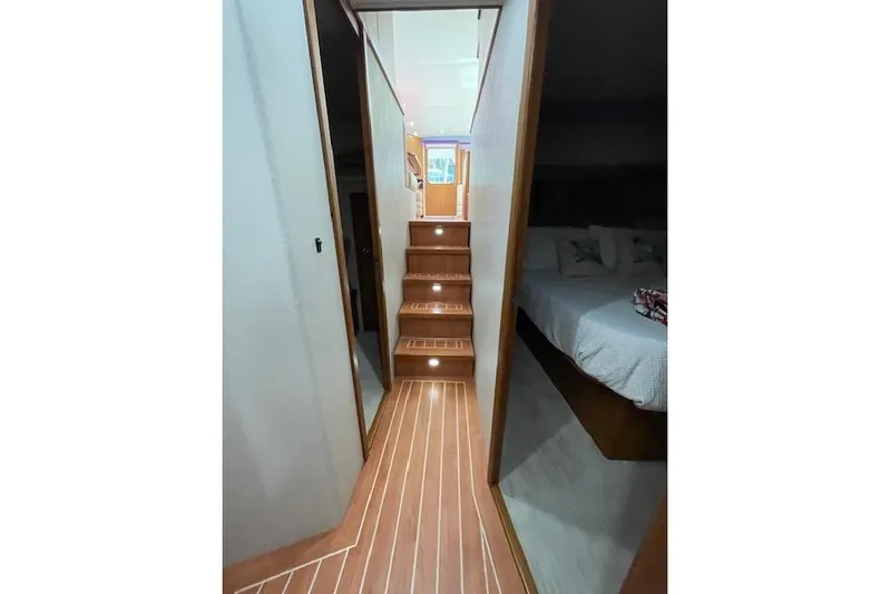Ala-ash Yacht Photos Pics Interior of 2003 Post Flybridge Convertible yacht with wooden stairs and cozy bedroom.