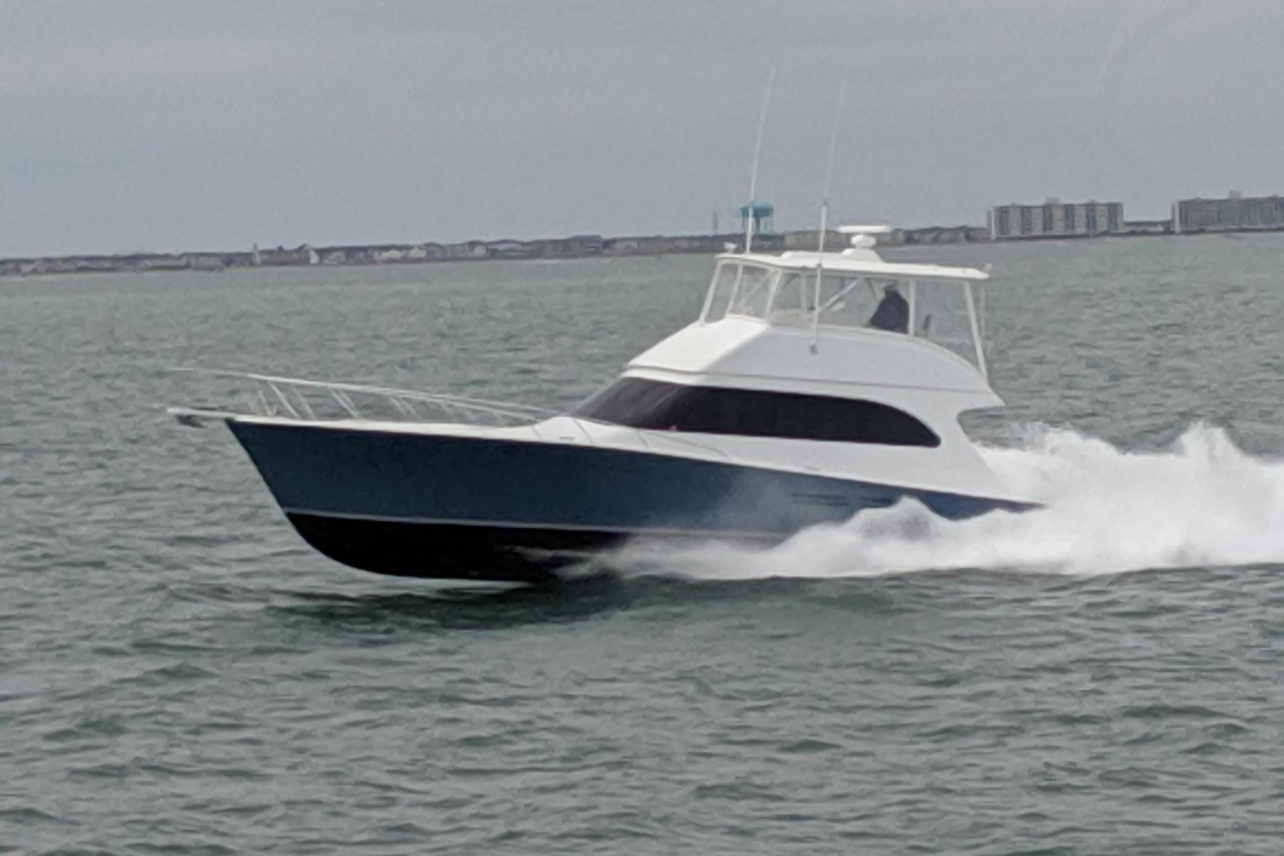 2003 Post Flybridge Convertible yacht cruising on open water.