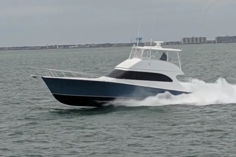 Ala-ash Yacht Photos Pics 2003 Post Flybridge Convertible yacht cruising on open water.