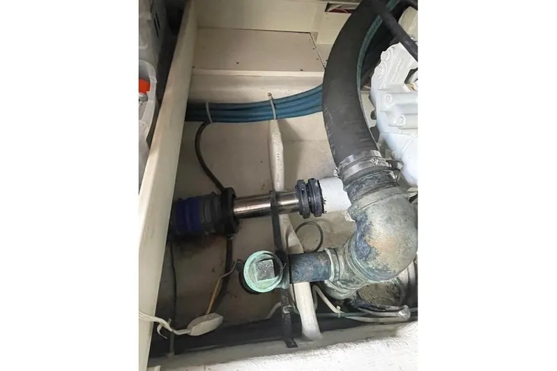 Ala-ash Yacht Photos Pics Engine compartment of a 2003 Post Flybridge Convertible boat, showing pipes and fittings.