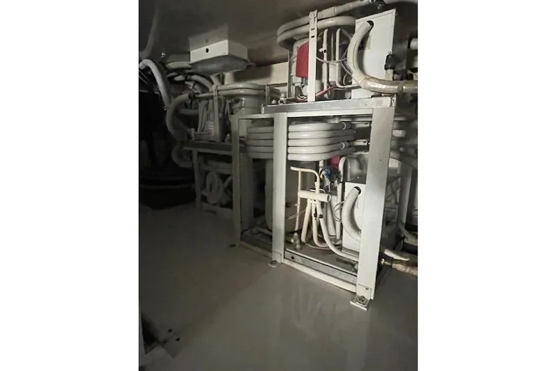 Ala-ash Yacht Photos Pics Engine room of 2003 Post Flybridge Convertible with complex piping and machinery.