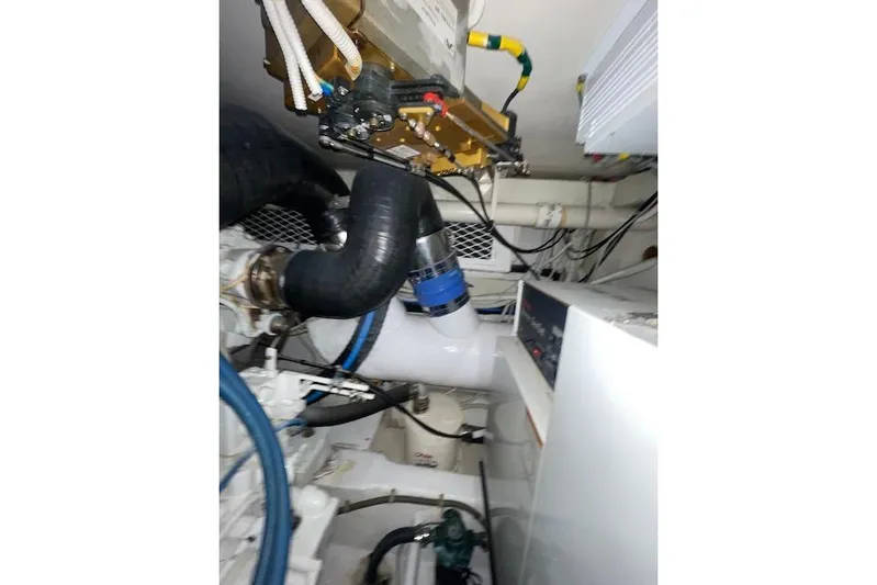 Ala-ash Yacht Photos Pics Engine room of 2003 Post Flybridge Convertible boat, showcasing mechanical components and wiring.
