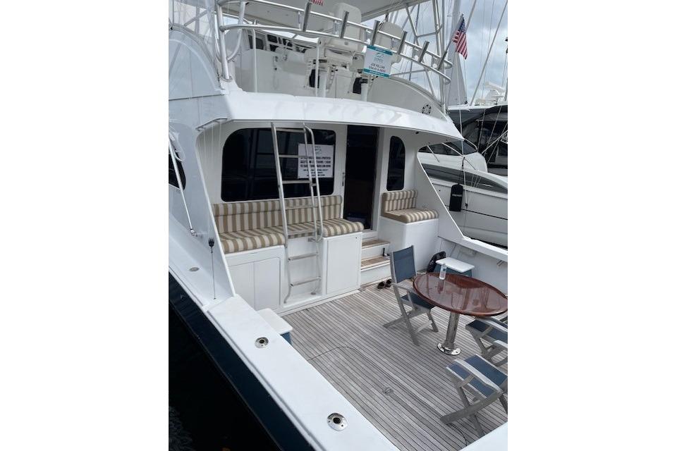 2003 Post Flybridge Convertible yacht with spacious deck and seating area.