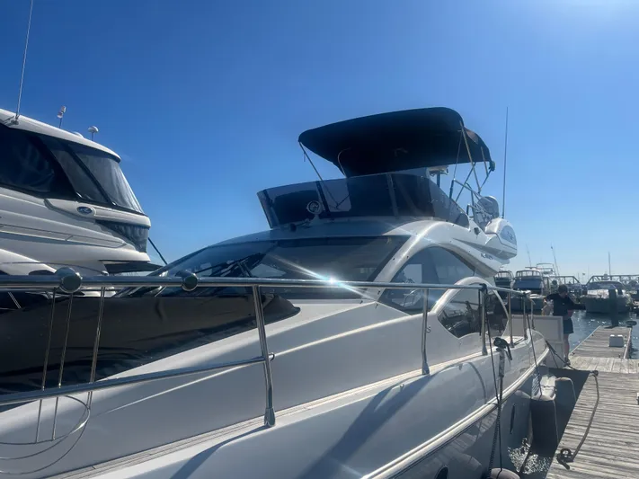  Yacht Photos Pics 2013 Azimut 40 Flybridge yacht docked under clear blue sky.