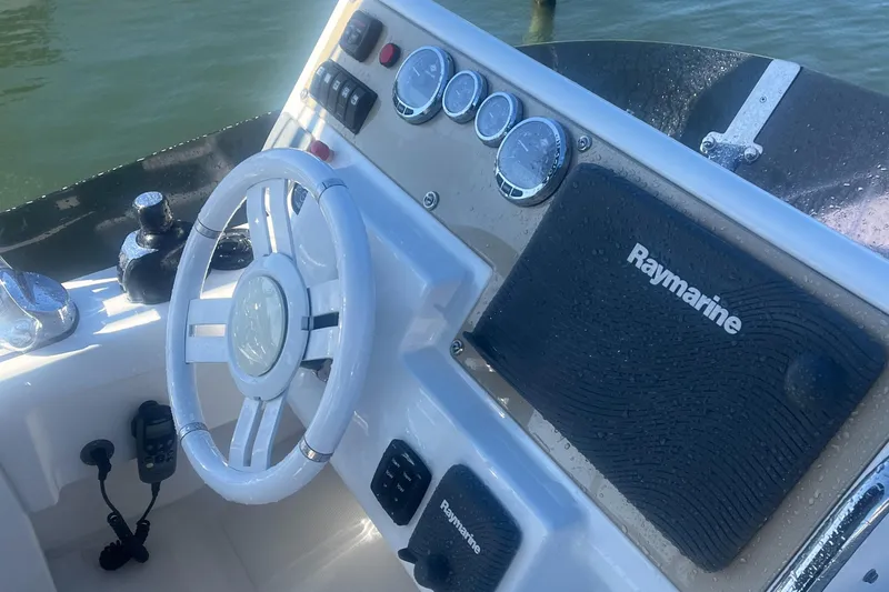  Yacht Photos Pics Steering console of 2013 Azimut 40 Flybridge with Raymarine navigation system.