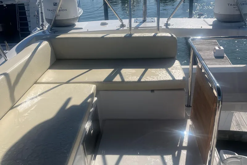  Yacht Photos Pics Azimut 40 Flybridge 2013 yacht seating area with beige cushions and water view.
