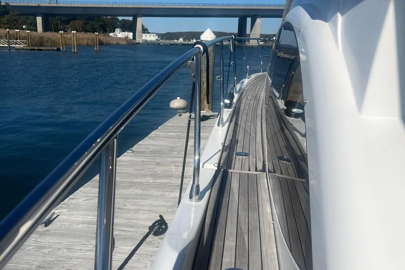  Yacht Photos Pics Azimut 40 Flybridge 2013 yacht docked by a wooden pier, with a scenic bridge view.