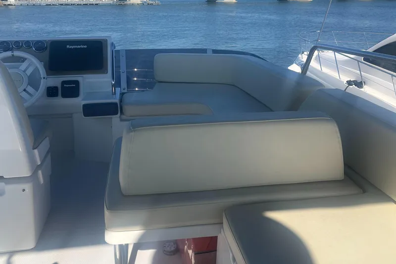  Yacht Photos Pics 2013 Azimut 40 Flybridge yacht interior with beige seating and navigation equipment.