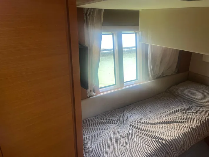  Yacht Photos Pics Cozy cabin interior of 2013 Azimut 40 Flybridge yacht with bed and window view.